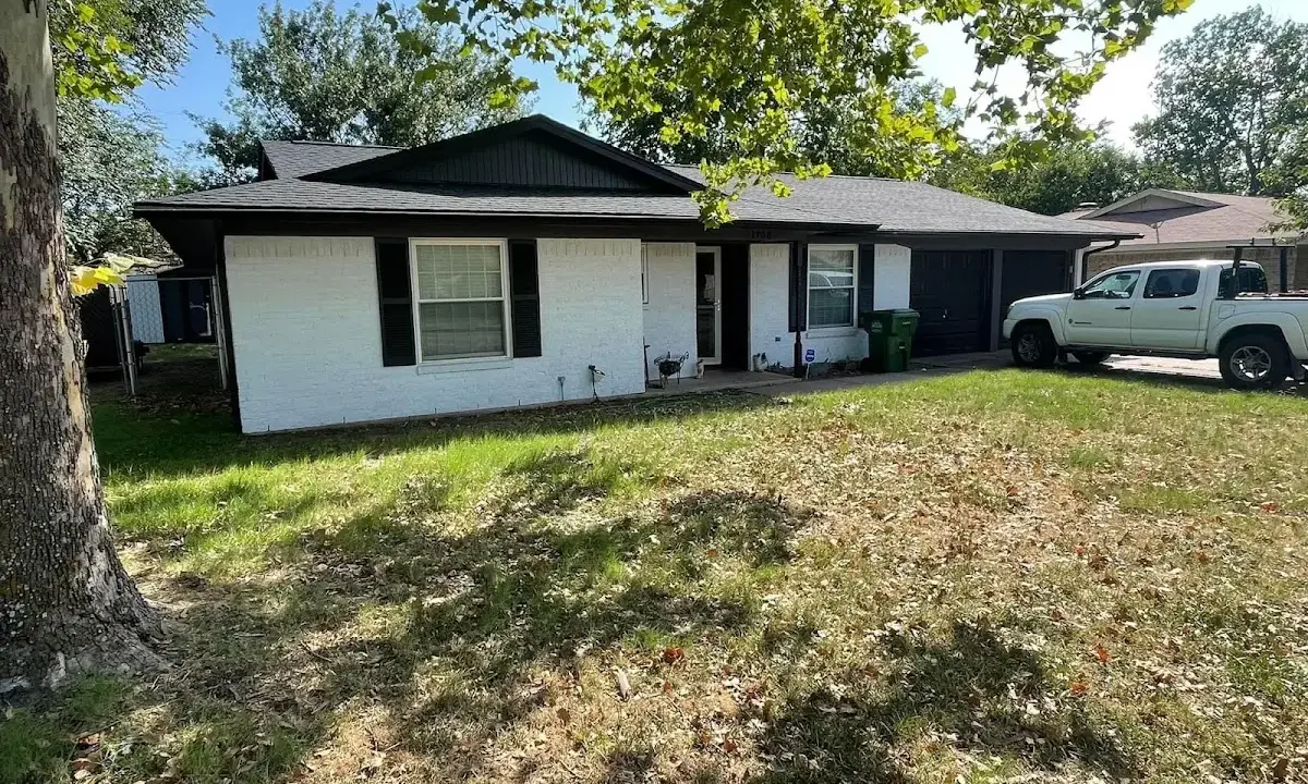 Professional roofing crew working on a residential roof in Laramie